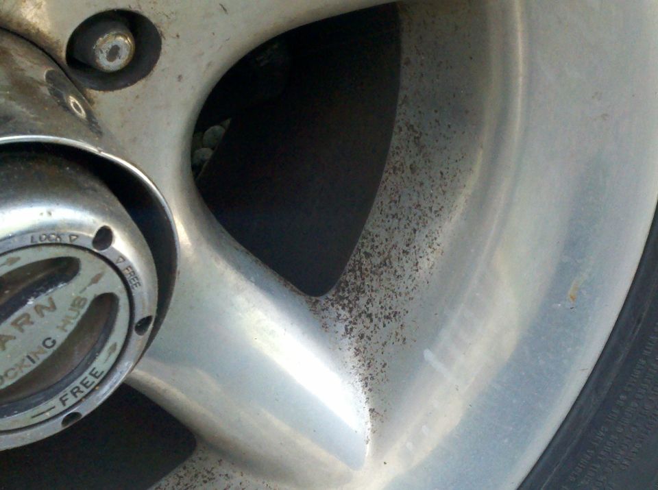 Close-up of an alloy wheel with a Warn locking hub center