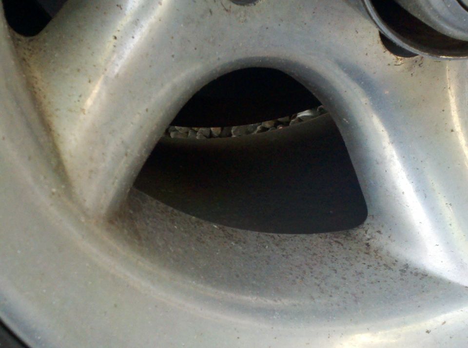 Extreme close-up of an alloy wheel spoke and brake component