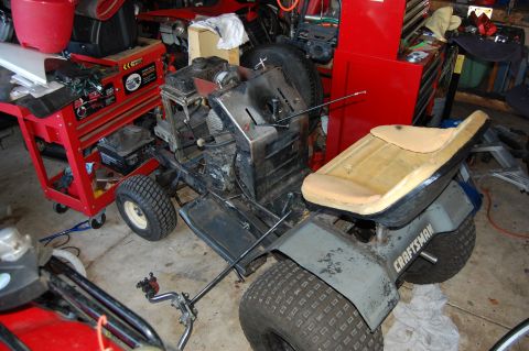 2010 Kawasaki BAYOU 220 - A CRAFTSMAN lawn tractor seat and fender are visible, along with its engine and wheels.