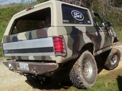 1995 Ford Bronco - This Ford Bronco features a custom camouflage paint job and appears to be modified for off-road use.