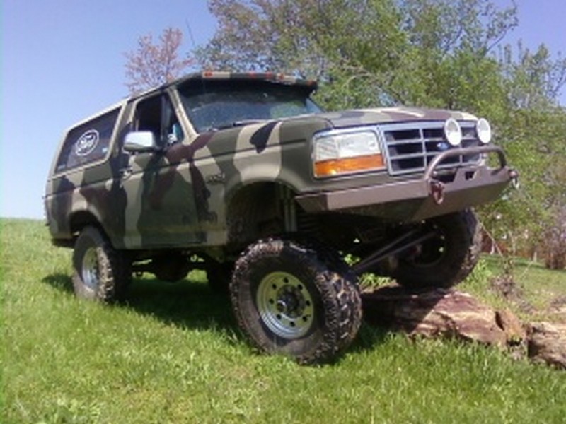 Camouflage 1995 Ford Bronco on rocks