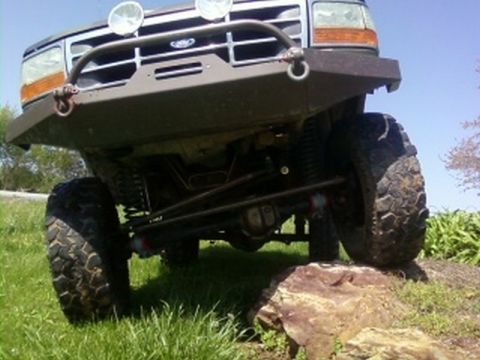 1995 Ford Bronco - Front view of a lifted 1992 Ford Bronco with an aftermarket bumper and large off-road tires.