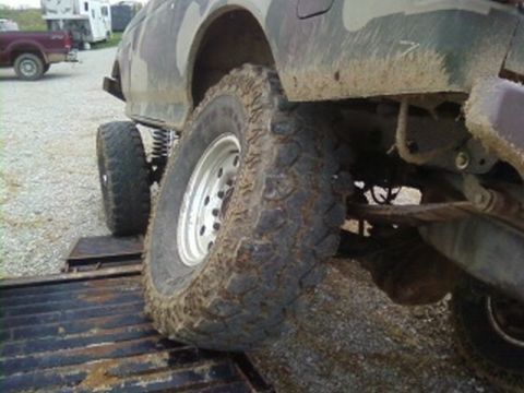 1995 Ford Bronco - Off-road vehicle tire on a ramp with another vehicle in the background.