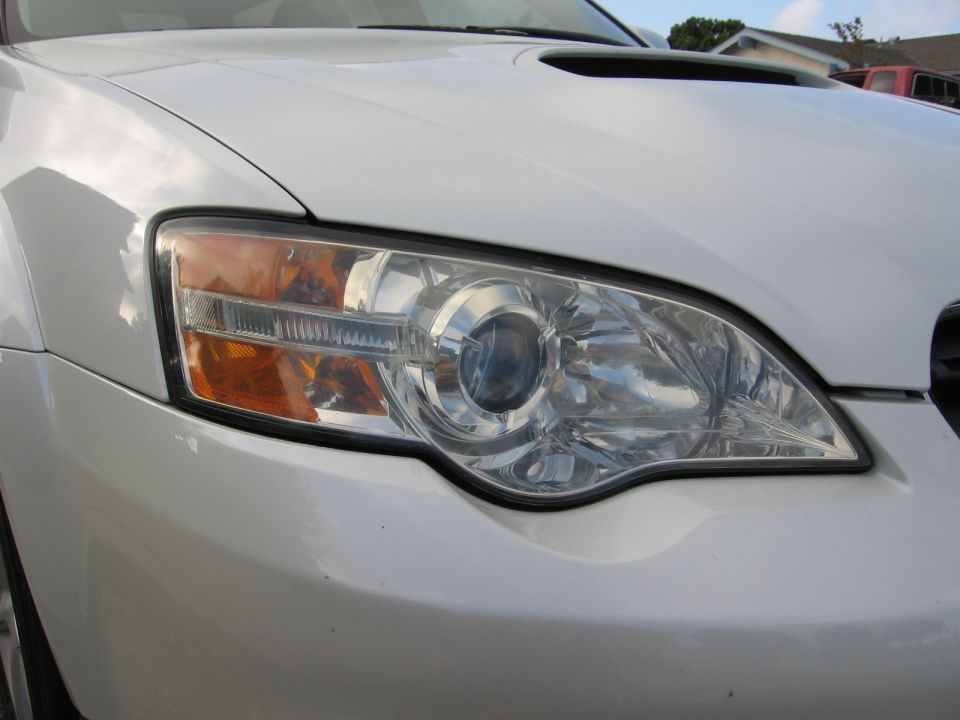 White SUV headlight and hood scoop