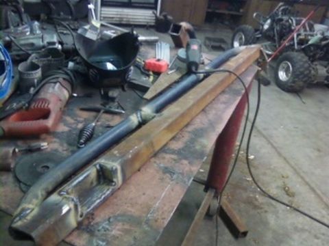 1995 Ford Bronco - Metal fabrication project underway in a cluttered garage with ATVs visible.