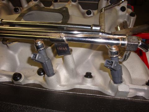 1989 Ford Bronco - Close-up of an engine's intake manifold, showing fuel injectors and fuel rails.