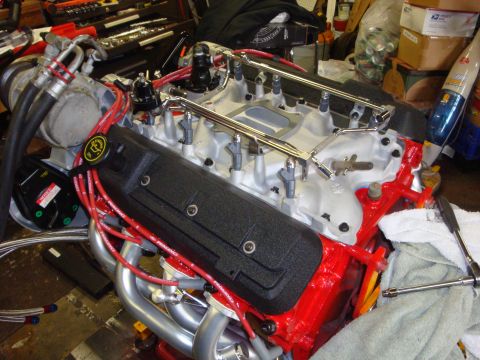 1989 Ford Bronco - Engine intake manifold assembly with fuel injectors and red spark plug wires attached.