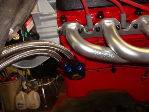 1989 Ford Bronco - Close-up of engine headers and braided oil lines, with 'Hedman' branding visible.