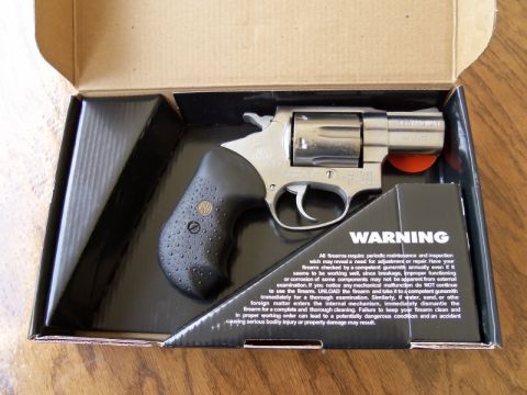 2000 Mercury Grand Marquis - A handgun is shown inside its packaging, accompanied by a warning label detailing firearm safety and maintenance.
