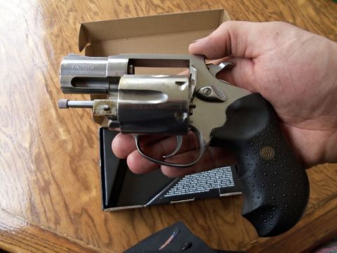 2000 Mercury Grand Marquis - A Rossi revolver is held in a hand over a box with printed text.