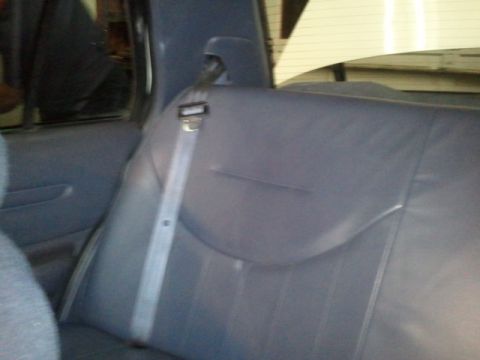 1998 Ford Crown Victoria - Interior shot of a blue cloth and vinyl rear bench seat with a newly installed shoulder belt running down the C-pillar to the seat cushion,…