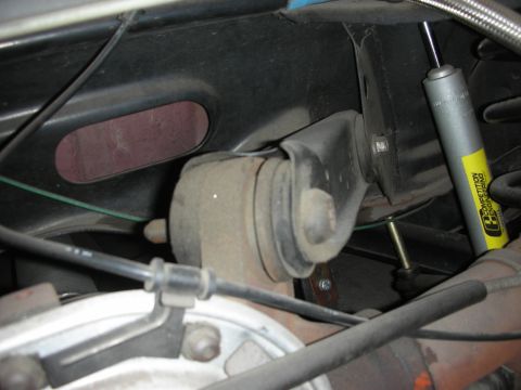 1998 Ford Crown Victoria - Close-up view of rear suspension parts, including a yellow Competition Engineering shock absorber.