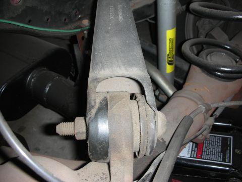 1998 Ford Crown Victoria - Rear suspension component with visible part number 125729.