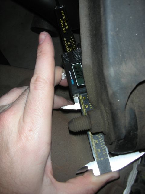 1998 Ford Crown Victoria - A digital caliper is used to measure the head of a bolt, showing a reading of 1.291 inches.