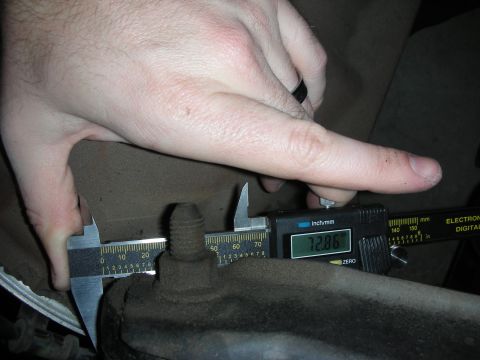 1998 Ford Crown Victoria - Digital calipers are used to measure a bolt's diameter, showing 12.86mm.