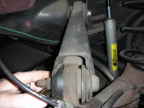 1998 Ford Crown Victoria - A hand is shown adjusting a bolt on a vehicle's rear suspension system, with a shock absorber a 'Competition Engineering' sticker.