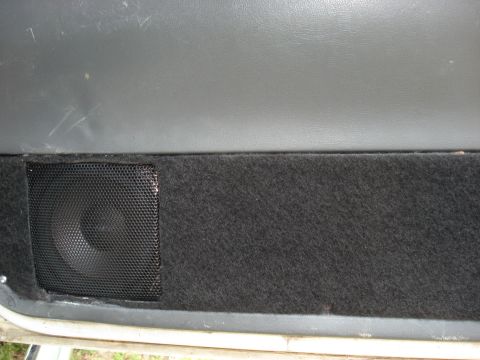 1992 Ford C-350 (Centurion Conversions) - Car door panel with a speaker and carpeted section visible.