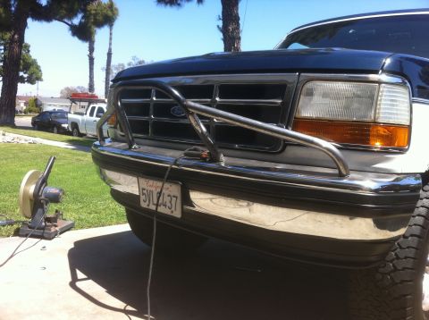 1995 Ford Bronco - Front view of a 1995 Ford Bronco with a bull bar installed, parked outside.