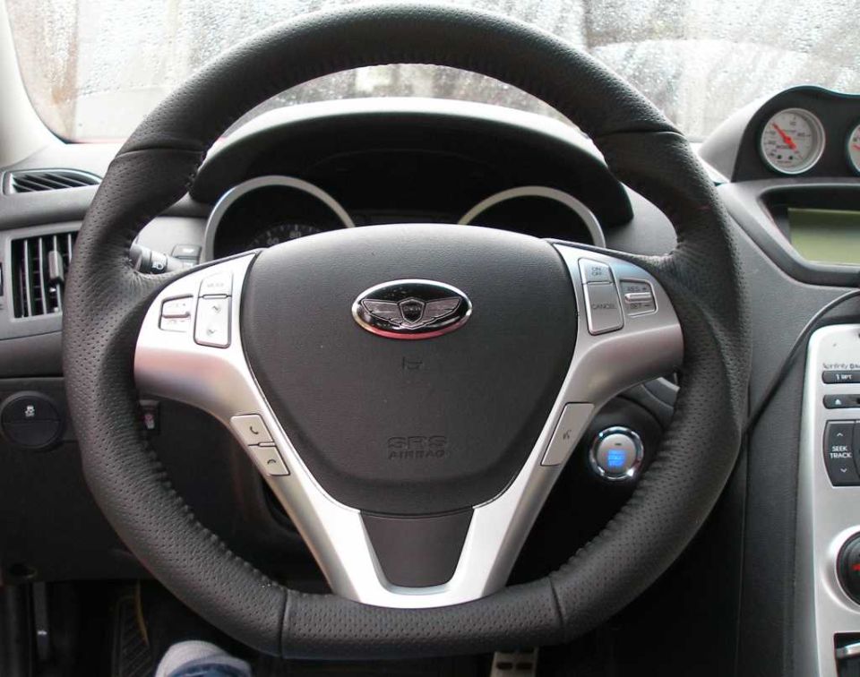 Steering wheel with Genesis badge and start button. 2010 Hyundai Genesis interior