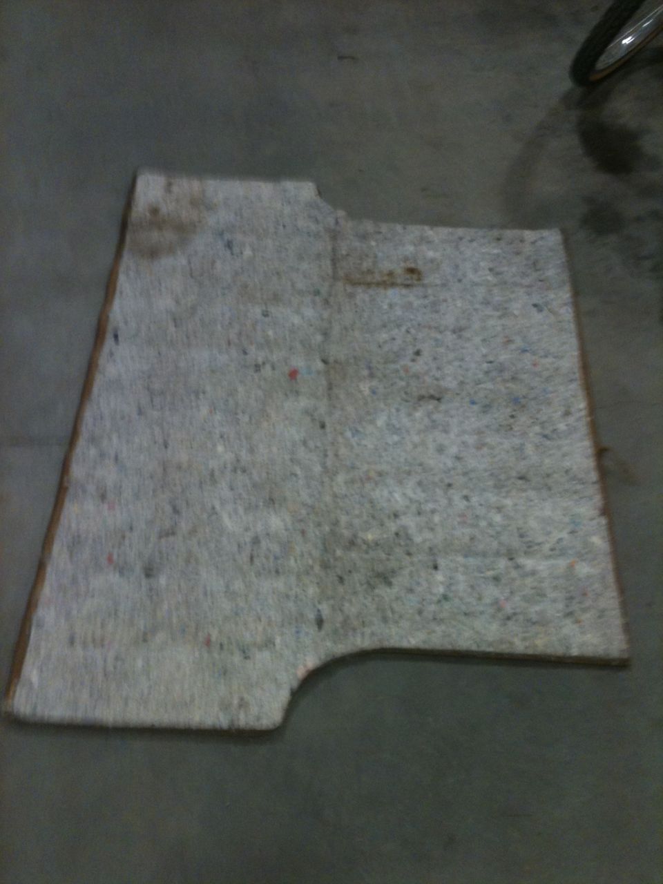 Gray carpet piece with cutouts