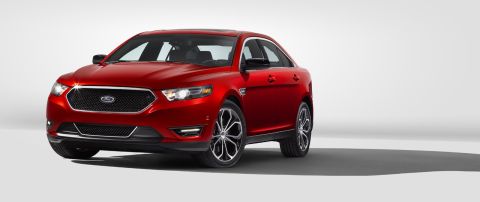 1993 Ford Taurus - Red Ford sedan shown from the front three-quarter angle against a white background.