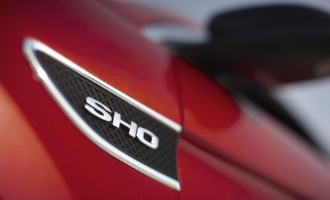 1993 Ford Taurus - The SHO badge is visible on the side of a red vehicle.