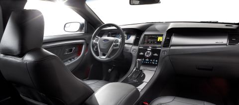1993 Ford Taurus - The interior of a car, a digital dashboard and a central console with a touchscreen display.