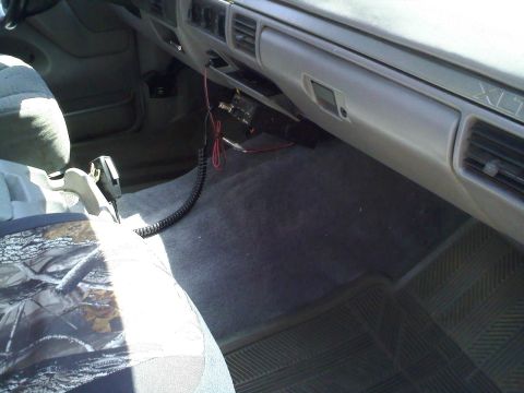 1994 Ford Bronco - The vehicle's interior features a CB radio and microphone, with a camouflage seat cover visible.