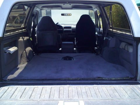 1994 Ford Bronco - Rear view of a 1994 Ford Bronco's interior, showing the cargo space and front seats.