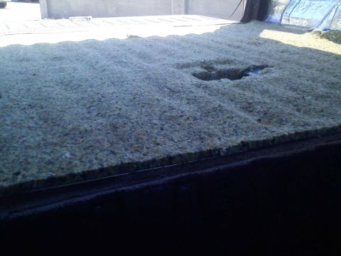 1994 Ford Bronco - Close-up of the insulation material in the cargo area of a vehicle.