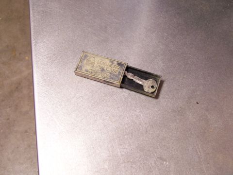 1989 Ford Bronco - A magnetic key case with a single key is shown on a metallic surface.