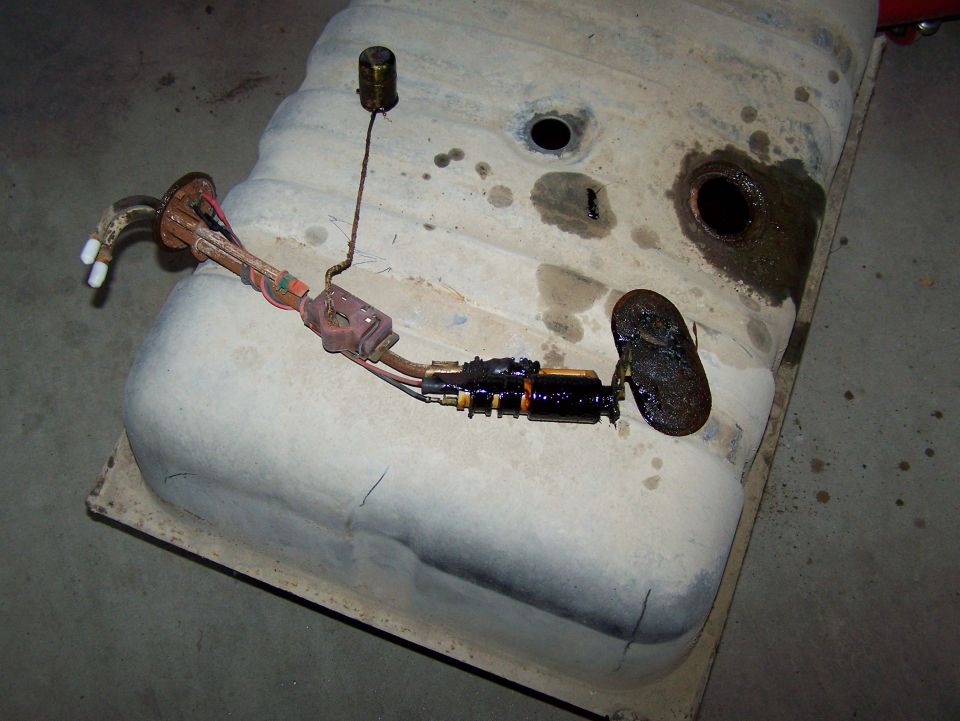 Fuel tank assembly with fuel pump and sending unit removed from a vehicle