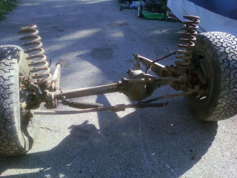 1989 Ford Bronco - This is a front axle assembly with suspension components and a tire, not a complete vehicle.