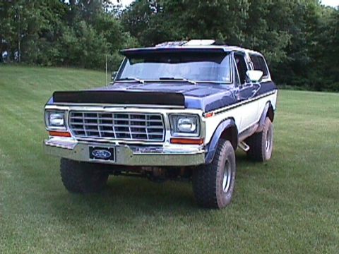 1978 Ford Bronco - This two-tone 1978 Ford Bronco is parked on a grassy field, a prominent bug deflector and a visor above the windshield.