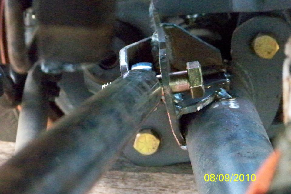 Close-up of custom axle swap modification with visible bolt and bracket