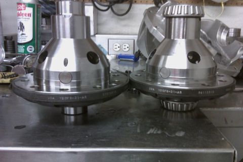 1999 Chevrolet Camaro - Two automotive differential gears are shown on a metal surface, with a can of cleaner in the background.