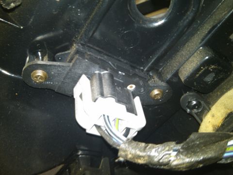 1993 Ford Bronco - This photo shows a close-up view of an electrical connector and its wiring harness within a vehicle's interior.