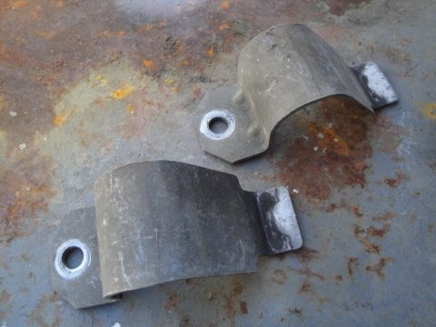 2003 Ford Taurus - These are sway bar brackets. The photo shows them on a rusty surface.