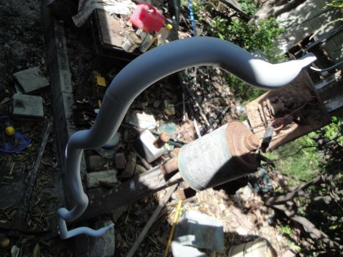 2003 Ford Taurus - A gray sway bar is pictured in a cluttered outdoor area with various discarded items.