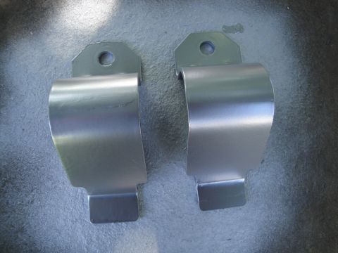 2003 Ford Taurus - Two silver metal sway bar brackets are shown against a textured gray background.