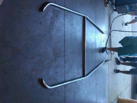 1995 Ford F-150 - A custom roll cage is laid out on a garage floor, ready for installation.