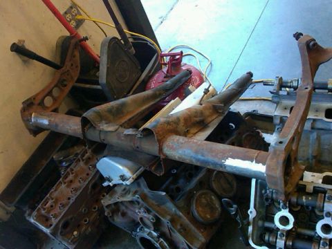 1995 Ford F-150 - A collection of disassembled and rusted vehicle parts, suggesting a project or salvage operation.