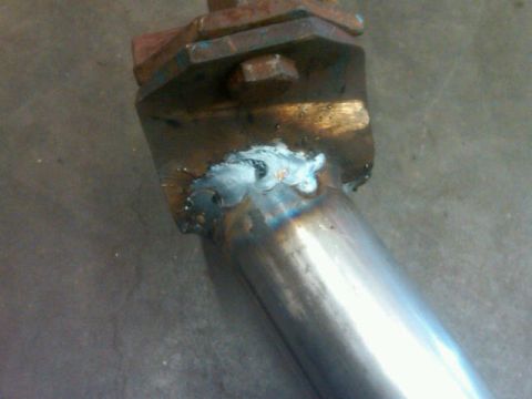 1995 Ford F-150 - A metal bracket is welded to a pipe, showing signs of repair or modification.