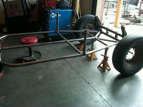 1995 Ford F-150 - A custom-built tube chassis is supported by jack stands in a workshop environment.