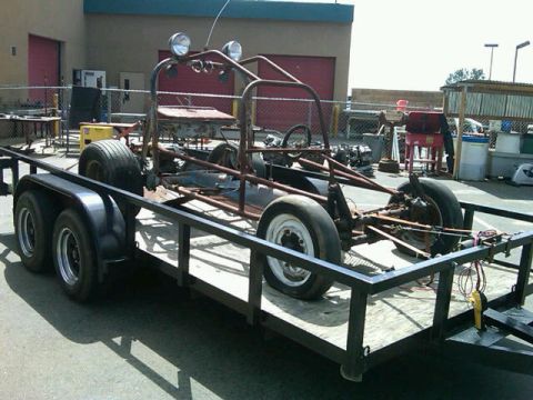 1995 Ford F-150 - A custom buggy project, appearing to be a frame-only build, is transported on a trailer. The exact year and make are not discernible from t…