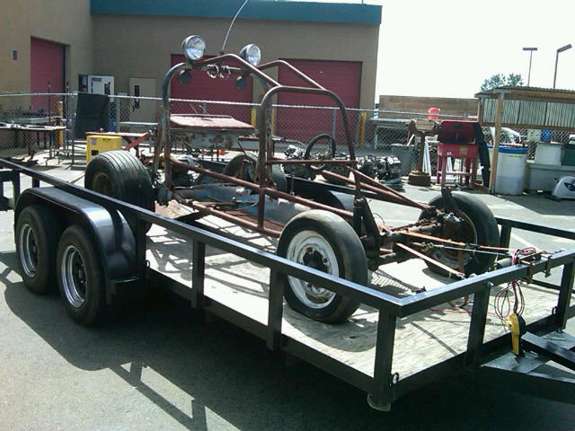 Custom buggy frame on trailer, side view. No year visible