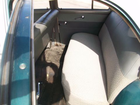 1952 Ford Mainline - The interior of a 1952 Ford Mainline shows the rear bench seat and door panel, with a watermark at the bottom right.