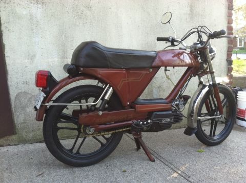 1981 Garelli Rally Sport - This Garelli moped is parked on a concrete surface against a textured wall.