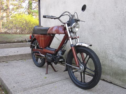 1981 Garelli Rally Sport - A brown moped is parked outdoors on a concrete surface.