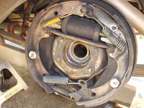 1964 Ford Fairlane - Drum brake assembly showing internal components like springs and the brake cylinder.